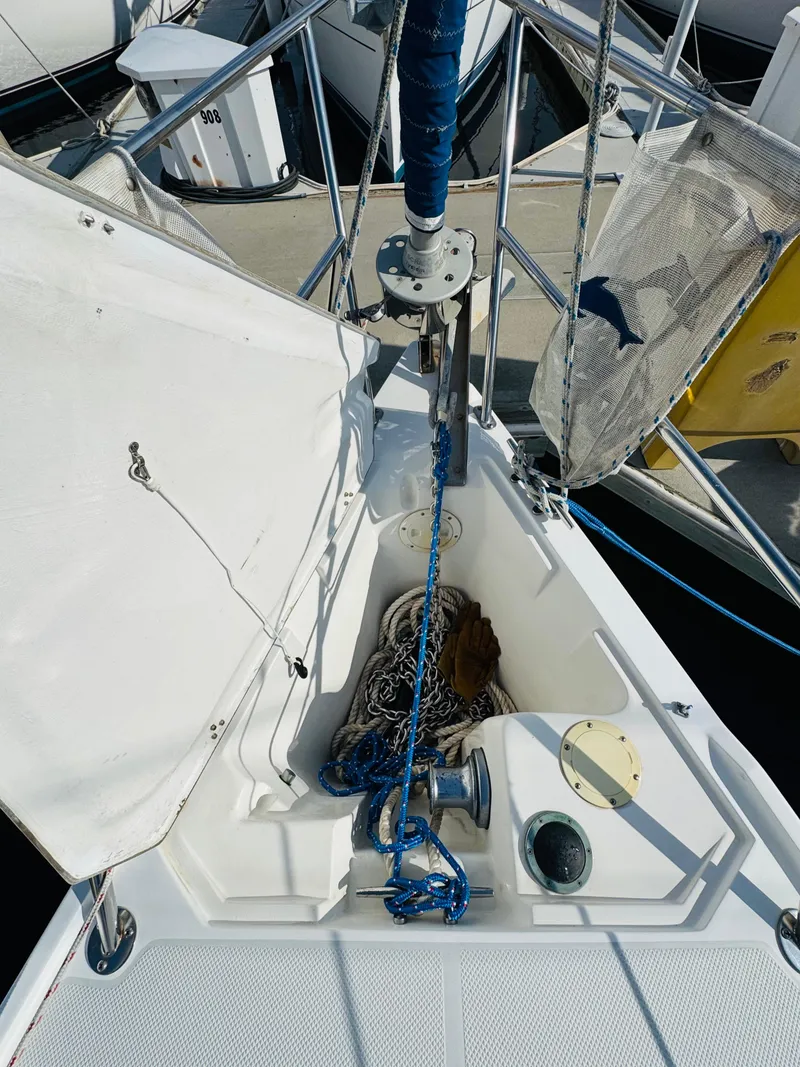 Slide: The Image of 1998 Catalina 320 sailboat deck with ropes and winch. - 14