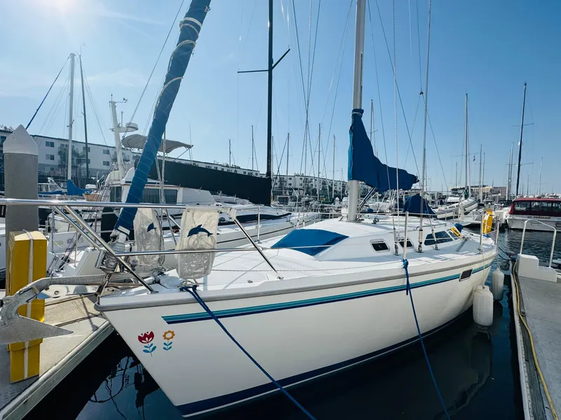 Slide: The Image of 1998 Catalina 320 sailboat docked at marina under clear blue sky. - 2