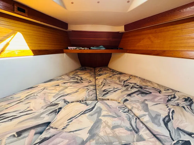 Slide: The Image of Cozy cabin interior of 1998 Catalina 320 sailboat with patterned bedding. - 25