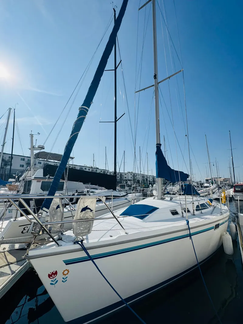 Slide: The Image of 1998 Catalina 320 sailboat docked in marina under clear blue sky. - 4