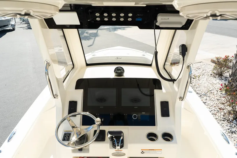 Slide: The Image of 2025 Scout 261 XSS boat dashboard with modern controls and dual screens. - 14