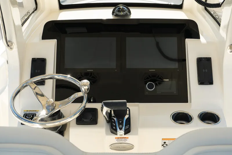 Slide: The Image of 2025 Scout 261 XSS boat dashboard with dual screens and steering wheel. - 15