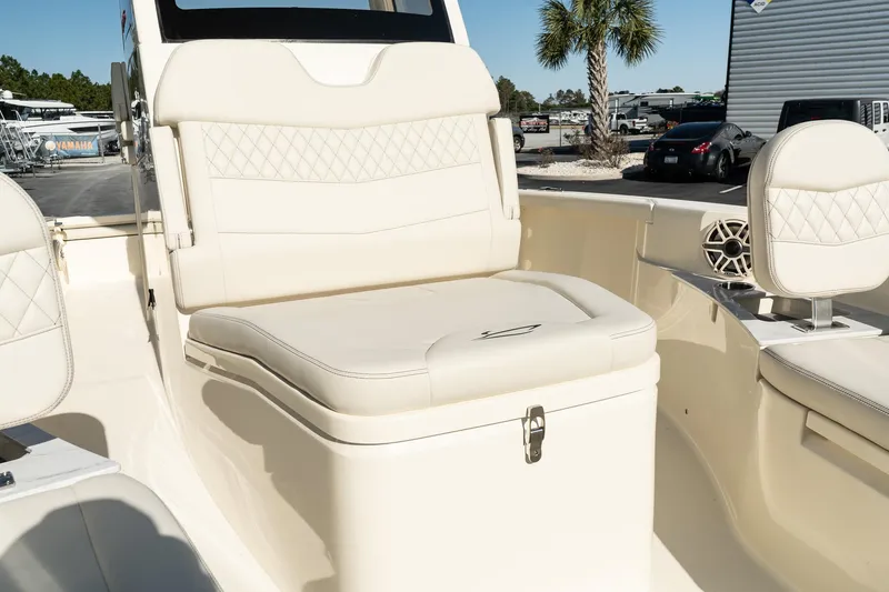 Slide: The Image of 2025 Scout 261 XSS boat interior with beige seating and storage. - 22