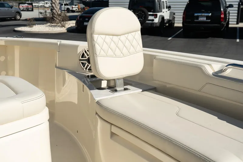 Slide: The Image of 2025 Scout 261 XSS boat interior with cream leather seating and speaker. - 23