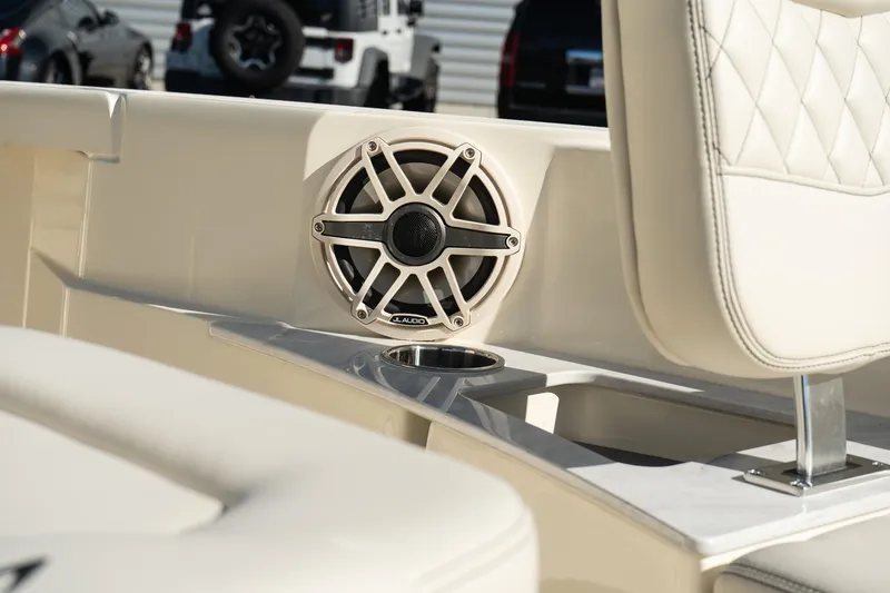 Slide: The Image of 2025 Scout 261 XSS boat interior with speaker and cushioned seating. - 25