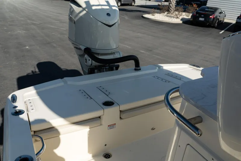 Slide: The Image of 2025 Scout 261 XSS boat with outboard motor in a parking lot. - 27