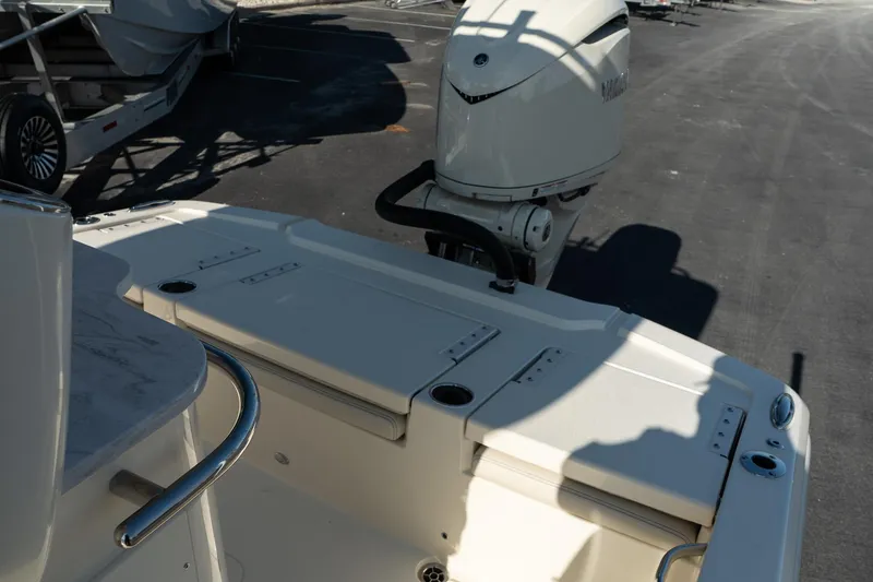 Slide: The Image of 2025 Scout 261 XSS boat with outboard motor in a parking area. - 28
