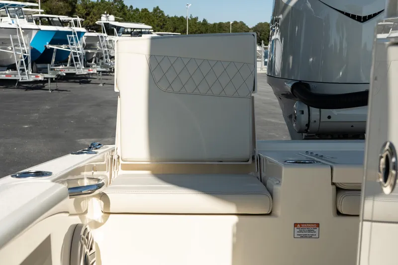 Slide: The Image of 2025 Scout 261 XSS boat interior with cushioned seating and motor detail. - 29