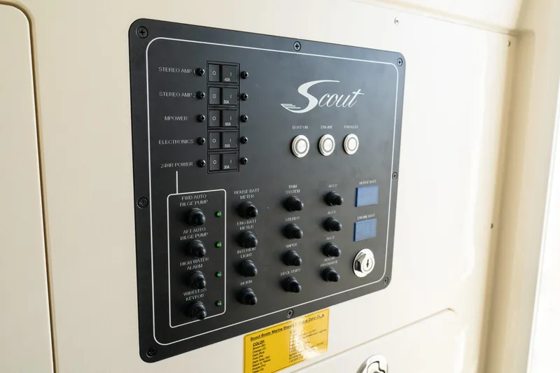 Slide: The Image of Control panel of 2025 Scout 261 XSS boat with switches and dials. - 32