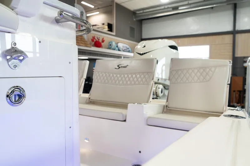 Slide: The Image of 2025 Scout 261 XSS boat interior with white seating and modern design. - 36