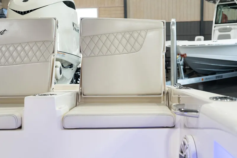 Slide: The Image of 2025 Scout 261 XSS boat interior with white cushioned seating. - 37