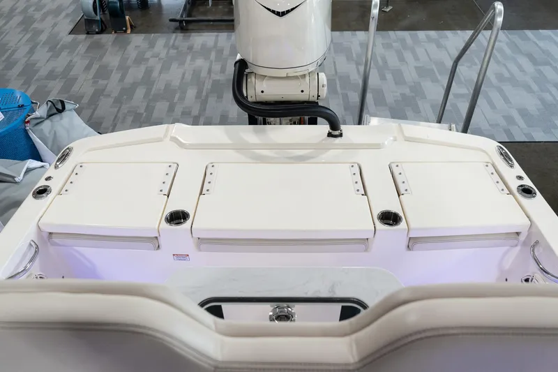 Slide: The Image of 2025 Scout 261 XSS boat interior with storage compartments and motor. - 39