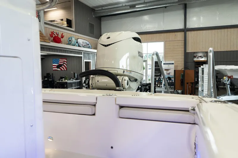 Slide: The Image of 2025 Scout 261 XSS boat in showroom with powerful outboard motor. - 40