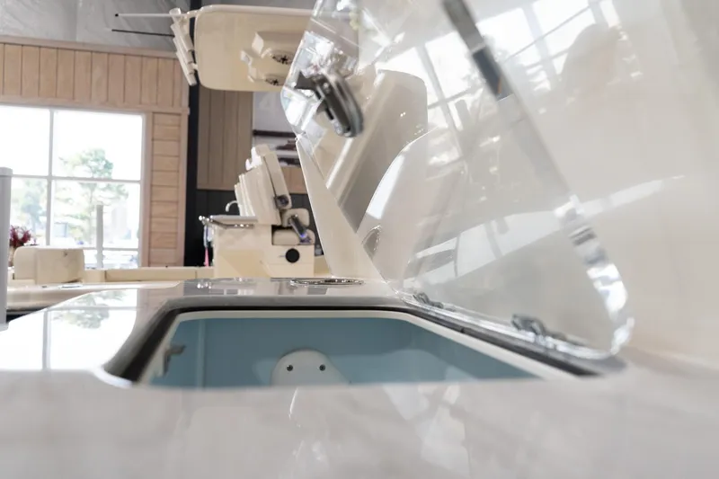 Slide: The Image of 2025 Scout 261 XSS boat interior detail with open storage compartment. - 44