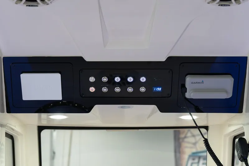 Slide: The Image of 2025 Scout 261 XSS boat control panel with modern navigation system. - 47