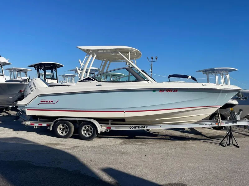 The Image of 2021 Boston Whaler 240 Vantage boat on trailer, side view, clear blue sky. - 0