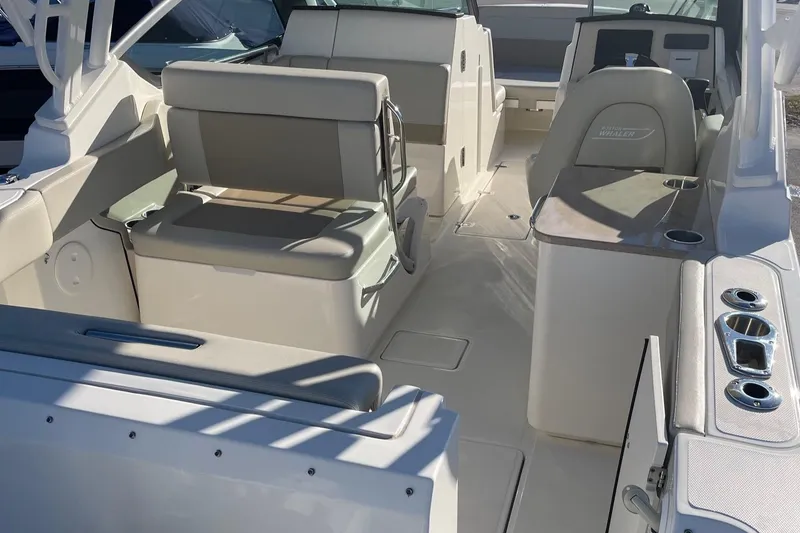 Slide: The Image of 2021 Boston Whaler 240 Vantage boat interior with seating and helm. - 13