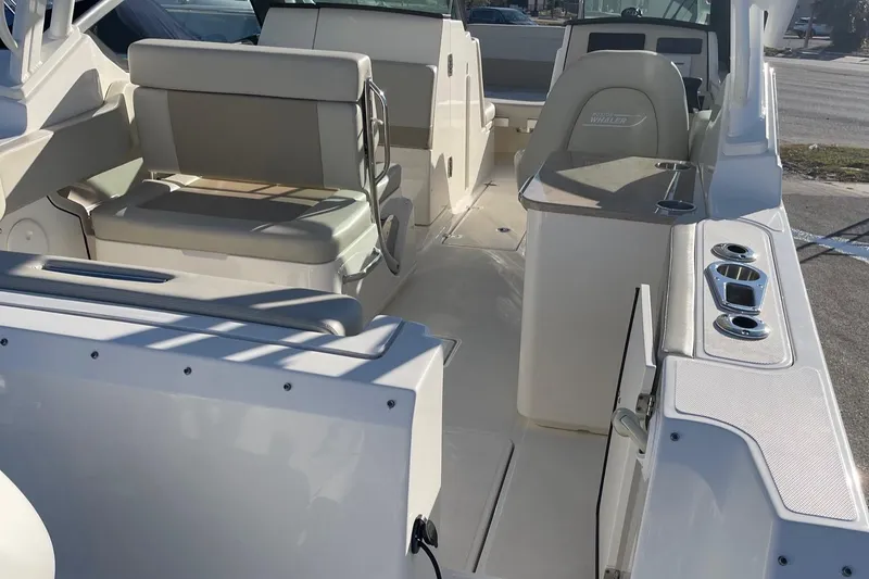 Slide: The Image of 2021 Boston Whaler 240 Vantage boat interior with seating and console. - 2