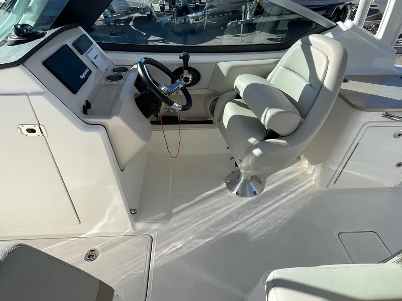 Slide: The Image of 2021 Boston Whaler 240 Vantage boat interior with helm and seating area. - 6