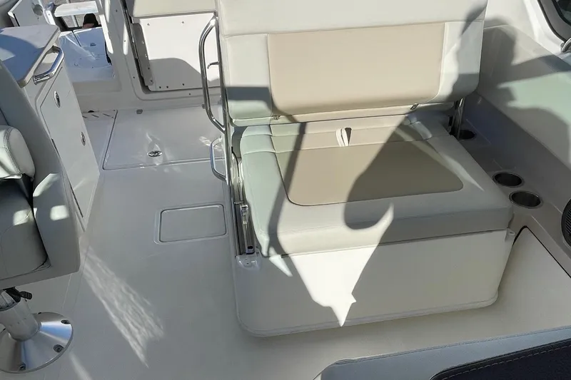 Slide: The Image of 2021 Boston Whaler 240 Vantage boat interior with cushioned seating and storage. - 9