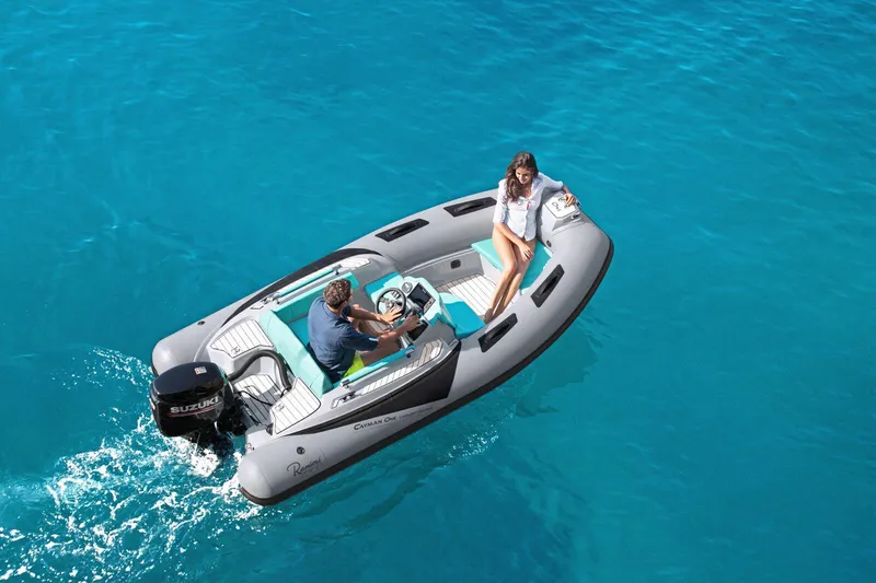 Slide: The Image of 2025 Ranieri CAYMAN ONE LUXURY TENDER on clear blue water, featuring sleek design and modern amenities. - 3