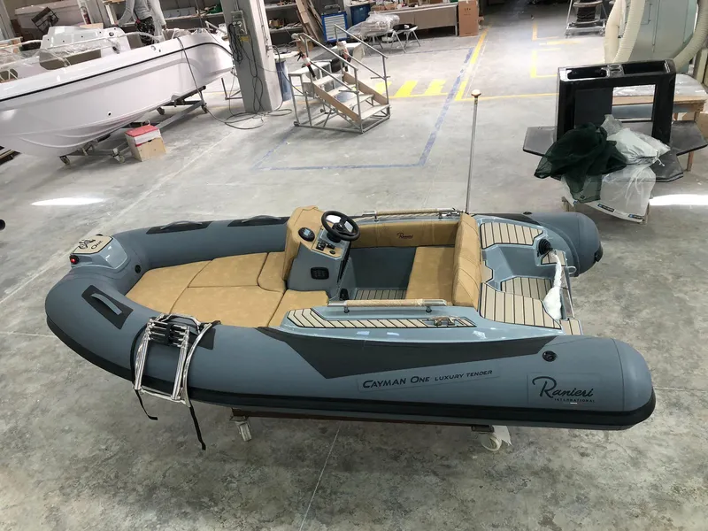 Slide: The Image of 2025 Ranieri CAYMAN ONE LUXURY TENDER in a workshop setting, showcasing sleek design. - 4