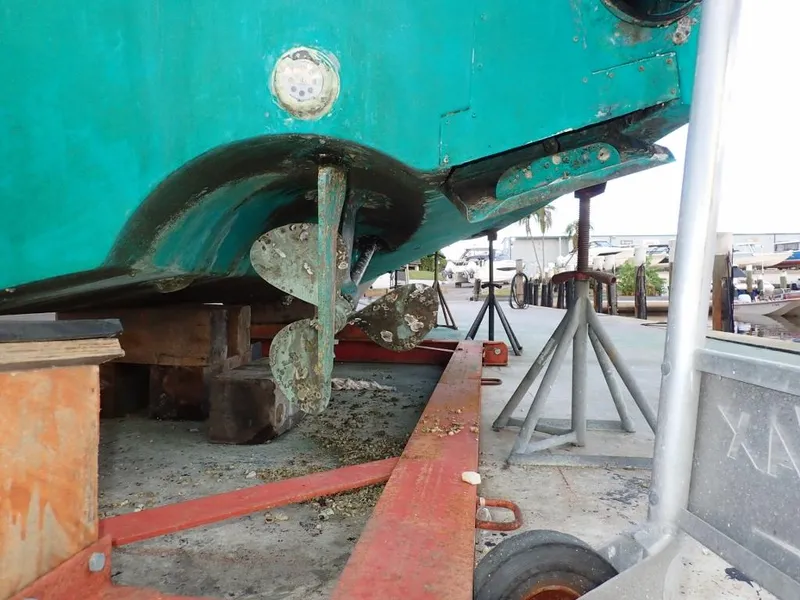 Slide: The Image of Cabo 35 Express 2000 boat on dry dock, showing propeller and hull maintenance. - 13