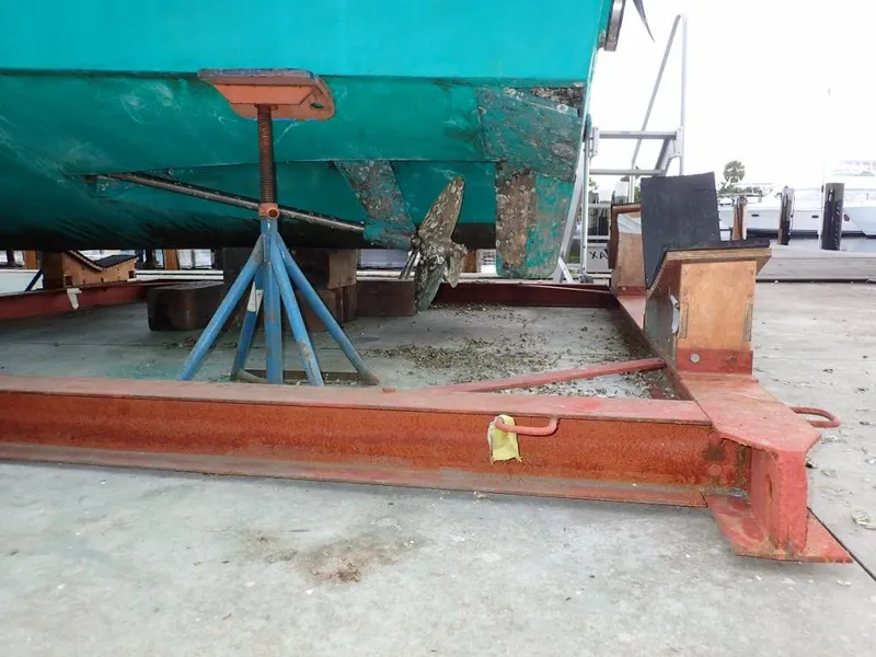 Slide: The Image of Cabo 35 Express 2000 boat on dry dock with visible propeller and support stands. - 15