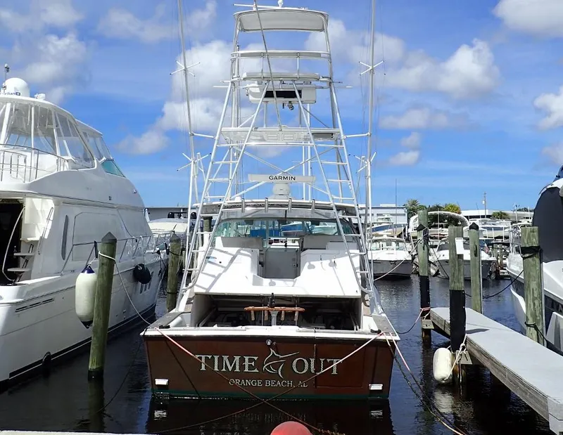 Slide: The Image of 2000 Cabo 35 Express boat docked at marina under blue sky. - 16