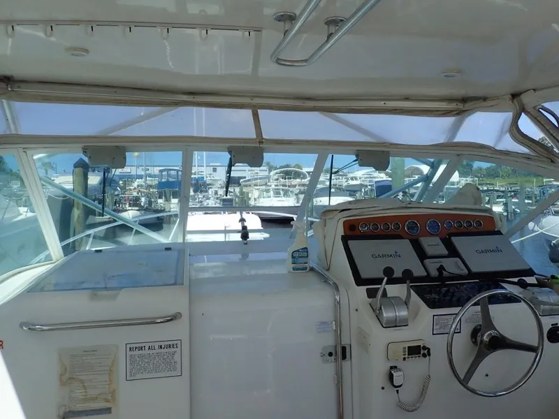 Slide: The Image of Interior view of a 2000 Cabo 35 Express boat cockpit with marina in background. - 18