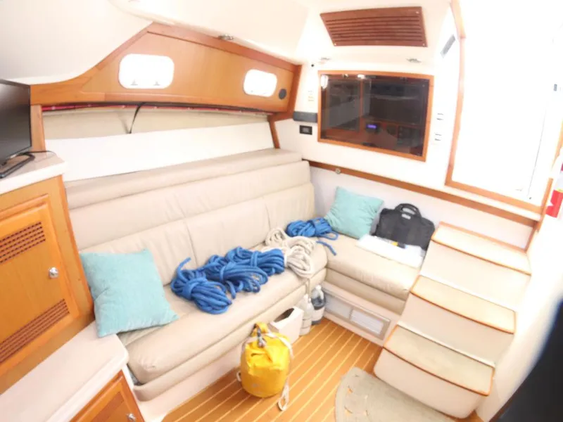 Slide: The Image of Interior of 2000 Cabo 35 Express boat with cozy seating and nautical decor. - 6