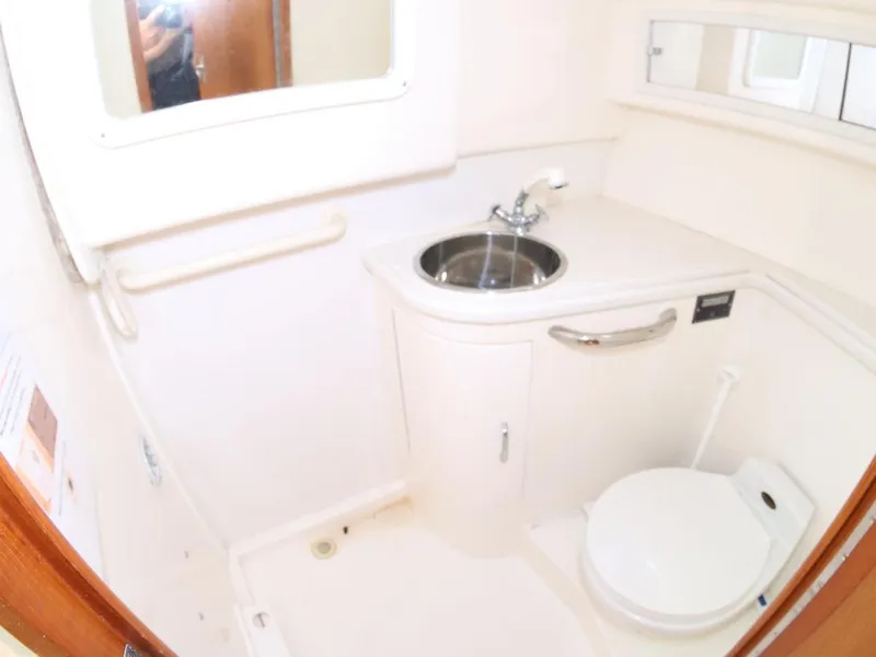 Slide: The Image of Compact bathroom in 2000 Cabo 35 Express boat with sink and toilet. - 7