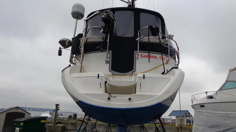 Slide: The Image of Blue Hunter 410 sailboat hull on stands, 2000 model, with visible propeller and rudder. - 12