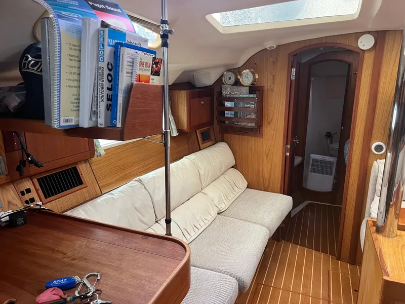 Slide: The Image of Interior of 2000 Hunter 410 sailboat with cozy seating and wooden finish. - 17