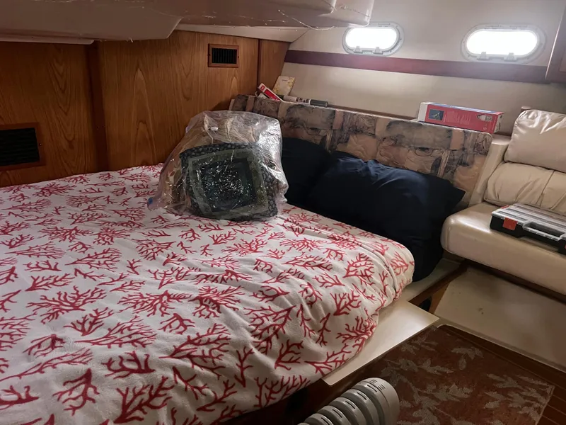 Slide: The Image of Cozy cabin interior of 2000 Hunter 410 sailboat with coral-patterned bedding. - 24