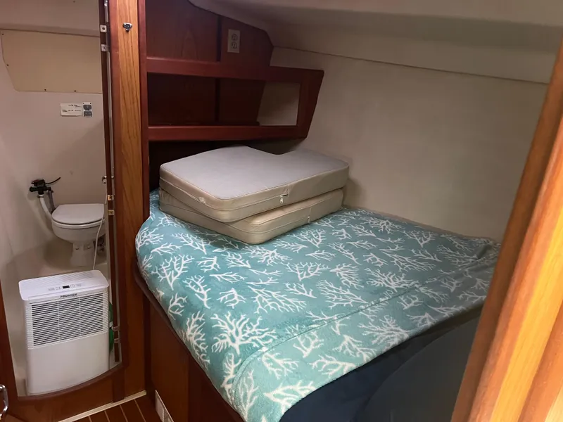 Slide: The Image of Cozy cabin interior of 2000 Hunter 410 sailboat with bed and compact bathroom. - 27