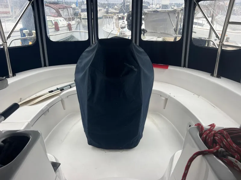 Slide: The Image of Interior view of a 2000 Hunter 410 sailboat cockpit with covered steering wheel. - 28