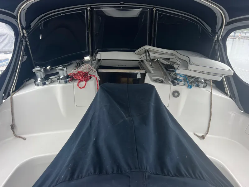 Slide: The Image of Interior view of a 2000 Hunter 410 sailboat cockpit with covered seating and winches. - 29