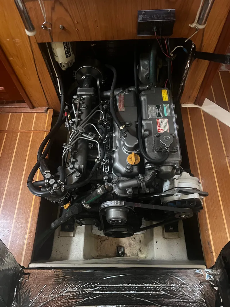 Slide: The Image of Engine compartment of a 2000 Hunter 410 sailboat, showcasing detailed mechanical components. - 30