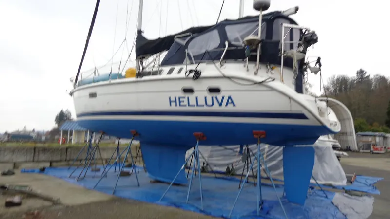 Slide: The Image of 2000 Hunter 410 sailboat docked at marina, rear view. - 4