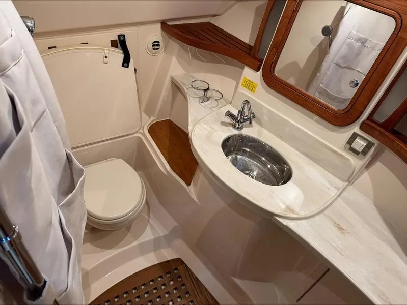 Slide: The Image of 2024 Grady-White 375 Freedom boat bathroom with sink, toilet, and mirror. - 12