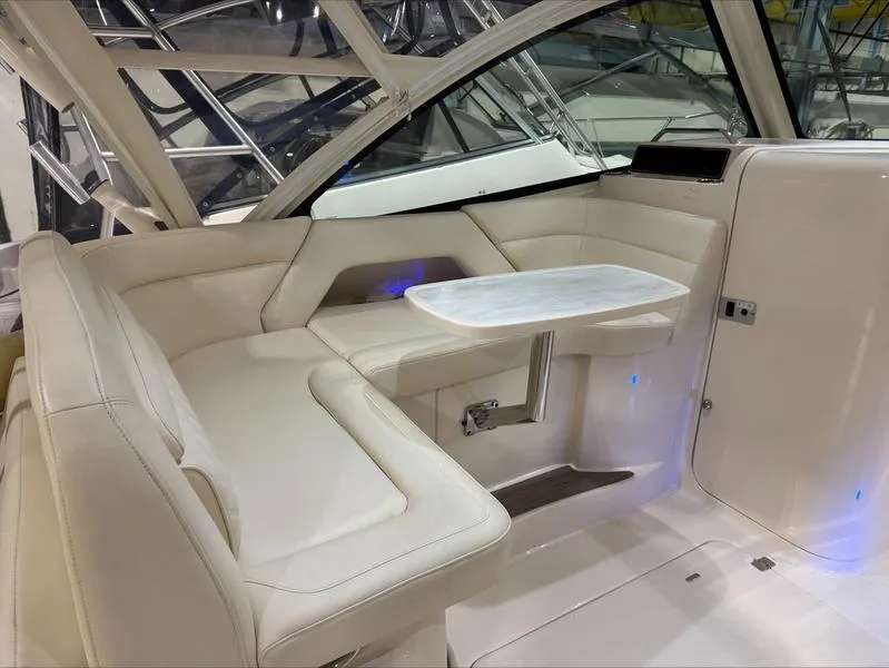 Slide: The Image of 2024 Grady-White 375 Freedom boat interior with white seating and a small table. - 3