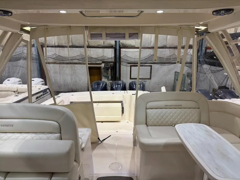 Slide: The Image of 2024 Grady-White 375 Freedom boat interior with luxurious seating and table. - 5