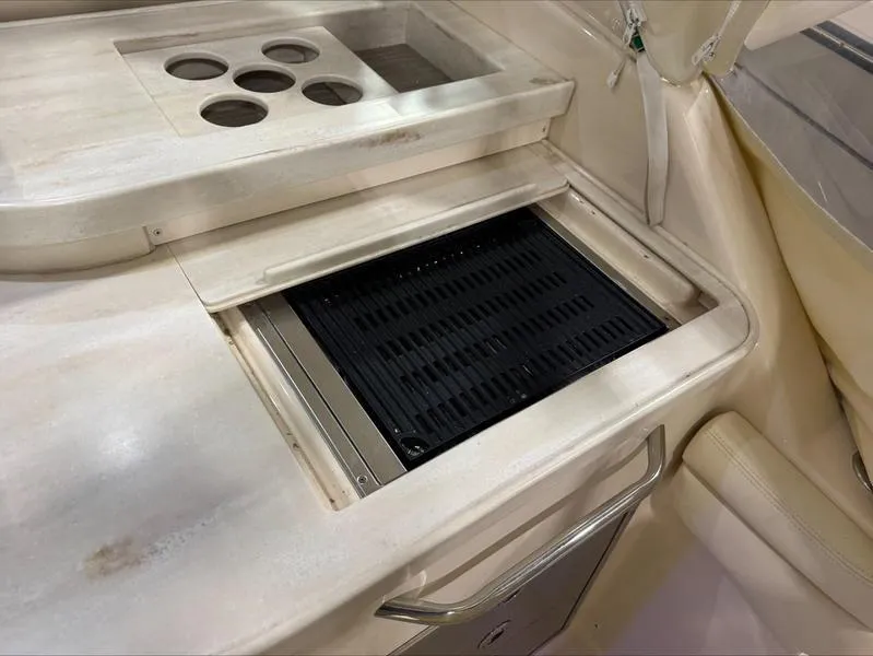 Slide: The Image of 2024 Grady-White 375 Freedom boat interior with built-in grill and cup holders. - 9