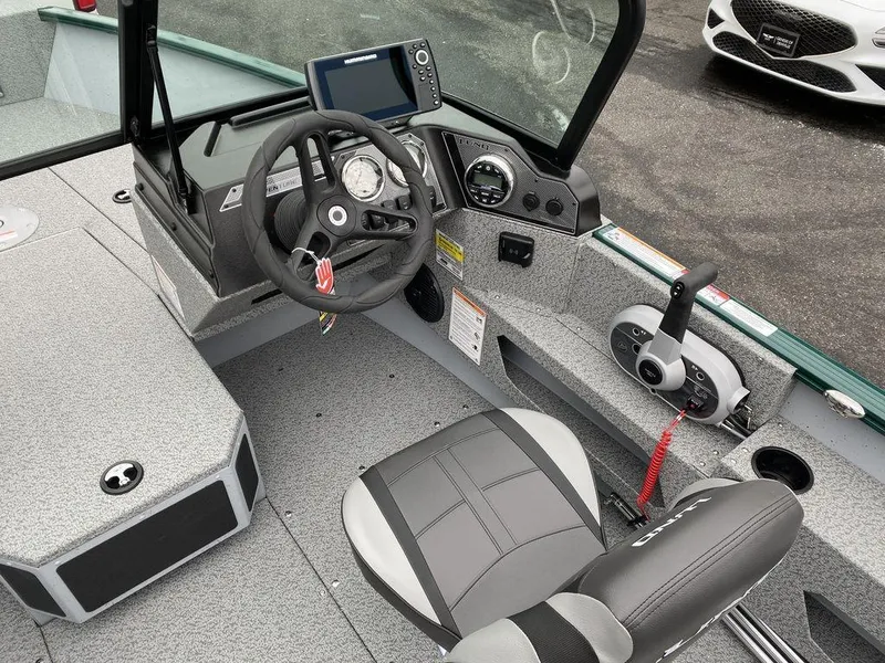 Slide: The Image of 2025 Lund 1775 Adventure Sport boat interior with steering wheel and control panel. - 10