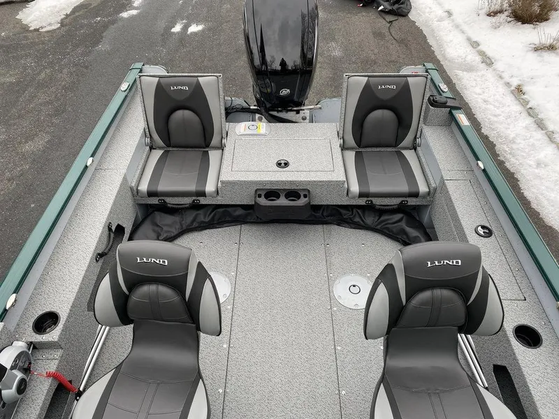 Slide: The Image of 2025 Lund 1775 Adventure Sport boat interior with four gray seats and a motor. - 12