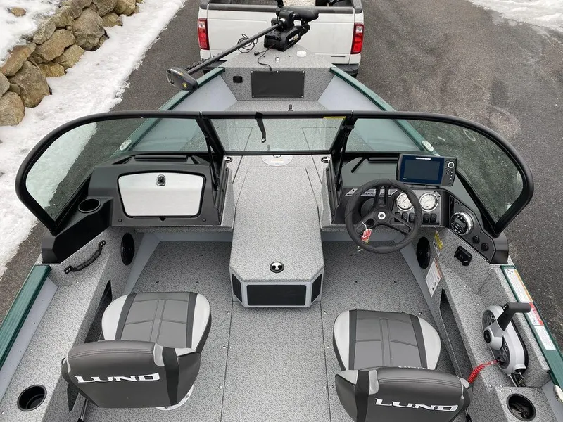 Slide: The Image of 2025 Lund 1775 Adventure Sport boat interior with dual seats and modern dashboard. - 14