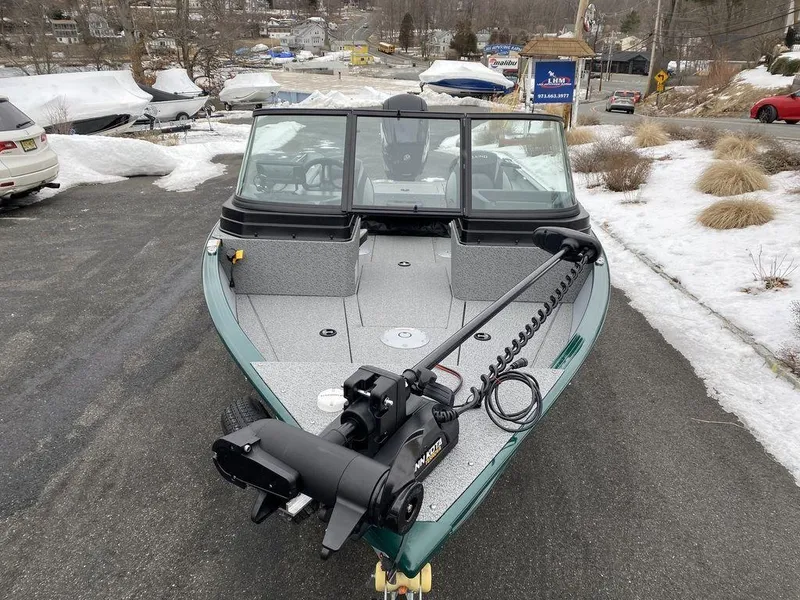 Slide: The Image of 2025 Lund 1775 Adventure Sport boat with trolling motor on snowy driveway. - 6