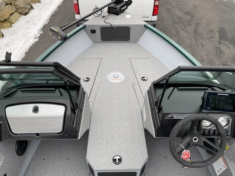 Slide: The Image of 2025 Lund 1775 Adventure Sport boat interior with steering wheel and open windshield. - 7