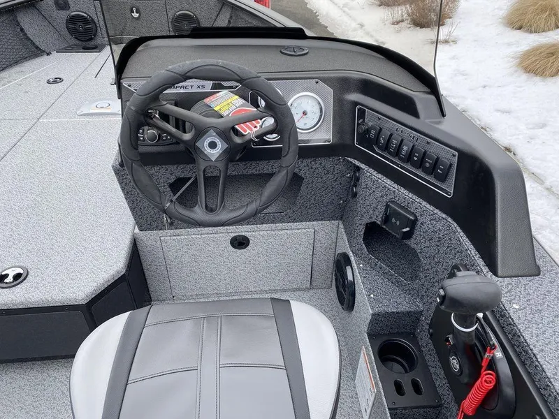 Slide: The Image of 2025 Lund 1775 Impact XS SS boat cockpit with steering wheel and controls. - 10